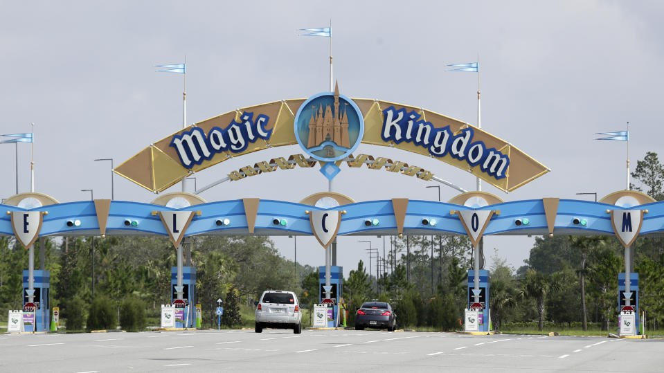 Park guests enter the Magic Kingdom during the reopening of Walt Disney World, Saturday, July 11, 2020, in Lake Buena Vista, Fla. (AP Photo/John Raoux)