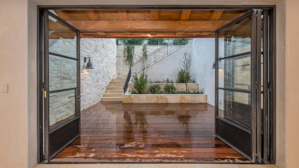 Retractable glass doors encourage indoor-outdoor living. - Credit: Paul Rollins