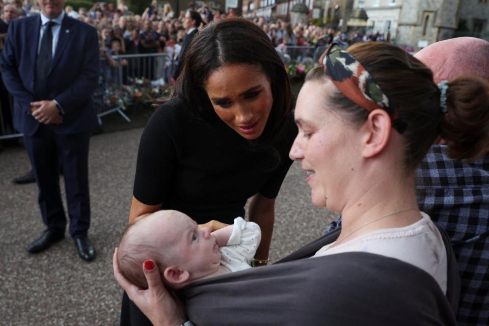 Meghan, the Duchess of Sussex, greets people gathered outside Windsor Castle, following the passing of Britain’s Queen Elizabeth (REUTERS)