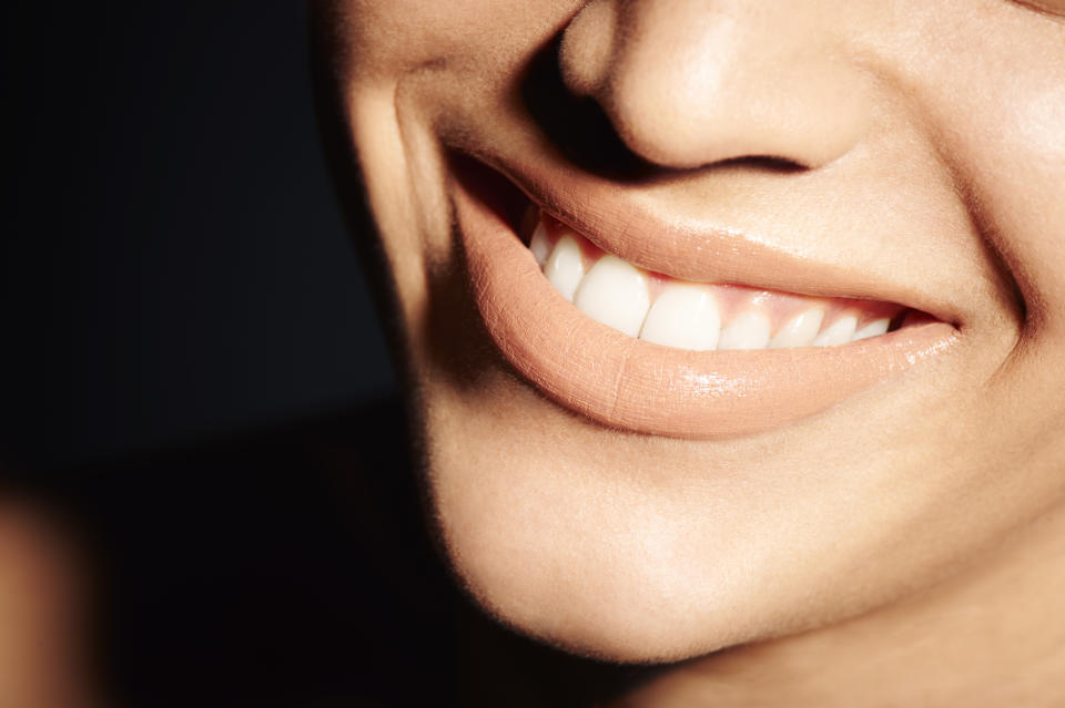 A woman's face up close, displaying a smile