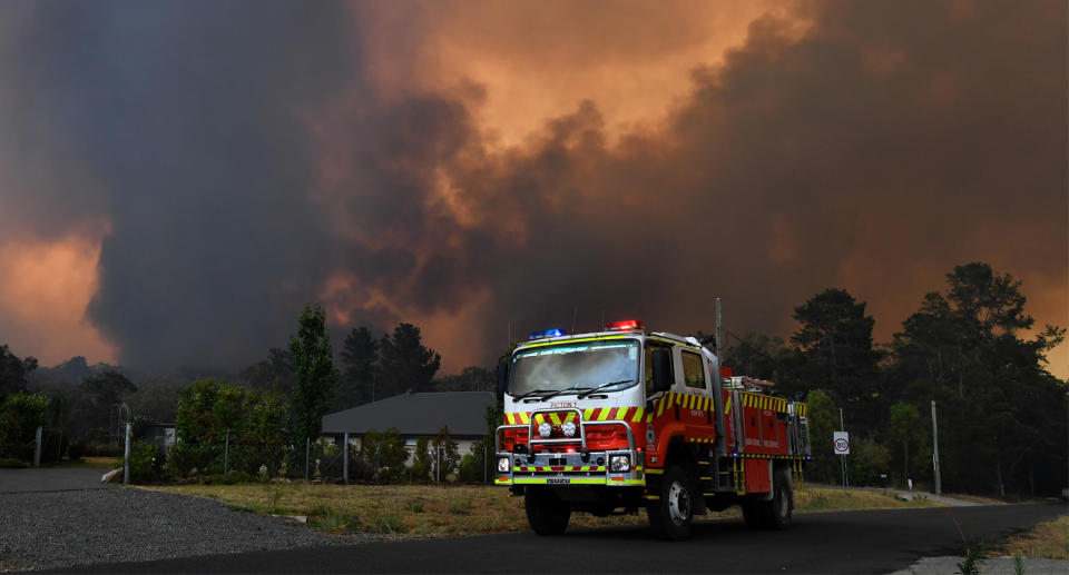 Rural Fire Service (RFS) crews prepare for the Green Wattle Creek Fire as it threatens homes in Yandeera.