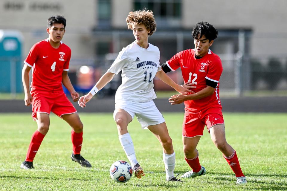 East Lansing's Xtreme Hauk, left, moves the ball as Everett's Cristian Solis defends during the first half on Tuesday, Sept. 12, 2023, at Everett High School in Lansing.