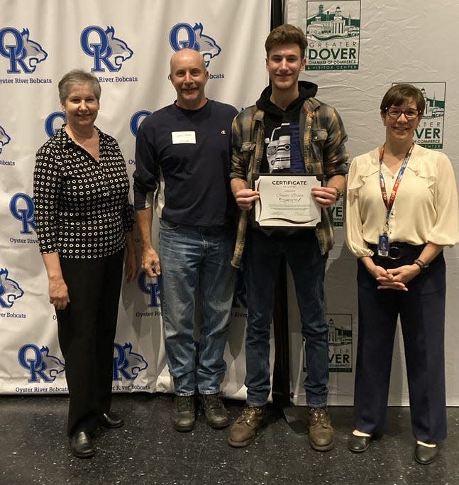 Oyster River graduating senior Connor Brown holds his certificate of intent to join the automotive technician team at Tri-City Chrysler Dodge Jeep Ram. With him are (left to right) Greater Dover Chamber of Commerce President Margaret Joyce; Connor's father, James Brown and ORHS Principal Rebecca Noe.