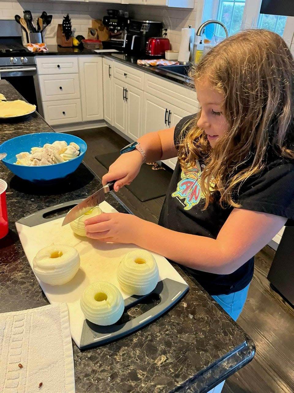 Lillia James, 9, is behind Them Apples, selling home-made apple sauce, apple butter, and apple pies from the orchard of her father's backyard in Hampton Falls.