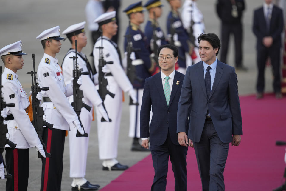 Canadian Prime Minister Justin Trudeau, right, is escorted by South Korea's Special Representative for Korean Peninsula Peace and Security Affairs Kim Gunn upon his arrival at the Seoul airport in Seongnam, South Korea, Tuesday, May 16, 2023. Trudeau arrived Tuesday in South Korea and will meet with South Korean President Yoon Suk Yeol, before heading to Japan for a G7 summit. (AP Photo/Lee Jin-man)