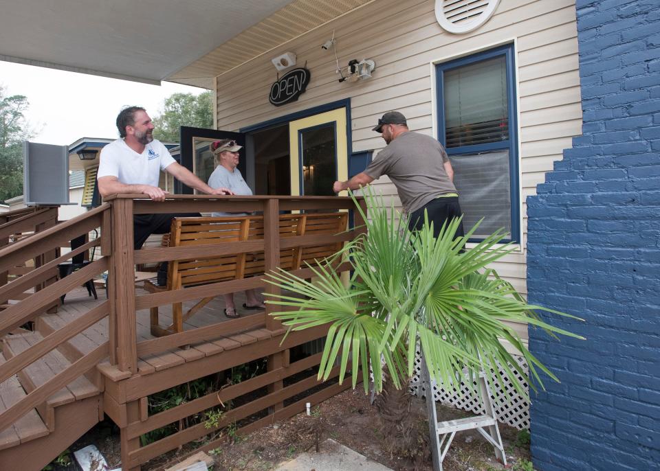 Mike Cosse, left, watches on Wednesday, Nov. 7, 2017, as work continues on his new Milton restaurant, Cosse's Place. The New Orleans-style restaurant is expected to open in late November.