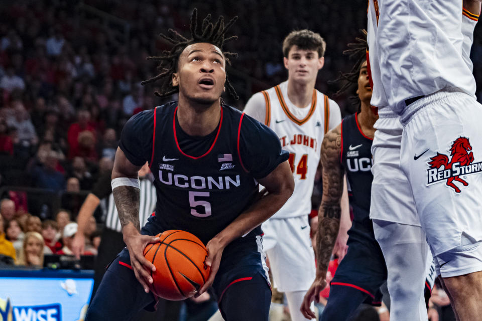 UConn guard Stephon Castle (5) looks to shoot as St. John's guard Chris Ledlum, right, defends during the first half of an NCAA college basketball game on Saturday, Feb. 3, 2024, in New York. (AP Photo/Peter K. Afriyie)