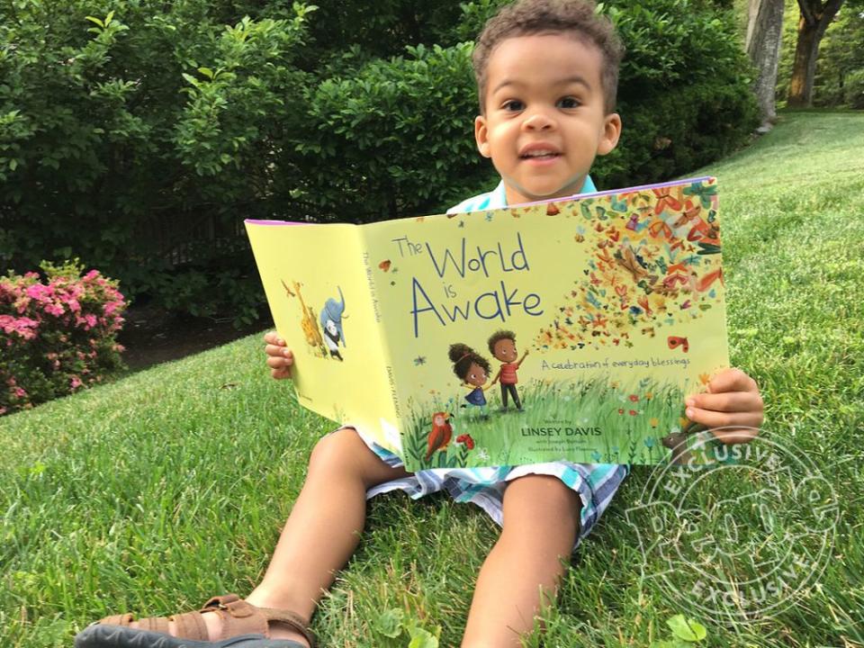 Linsey Davis' son Ayden with her new book, <em>The Wrld Is Awake</em>