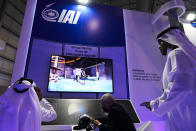 An Emirati examines a virtual reality display at the Israel Aerospace Industries stand at the Dubai Air Show in Dubai, United Arab Emirates, Monday, Nov. 15, 2021. Israel is taking part in the Dubai Air Show for the first time after the United Arab Emirates recognized the country. (AP Photo/Jon Gambrell)