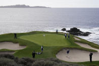 Henrik Norlander, of Sweden, hits out of a bunker up to the seventh green of the Pebble Beach Golf Links during the third round of the AT&T Pebble Beach Pro-Am golf tournament Saturday, Feb. 13, 2021, in Pebble Beach, Calif. Looking on at top is Jordan Spieth and at right is Daniel Berger. (AP Photo/Eric Risberg)