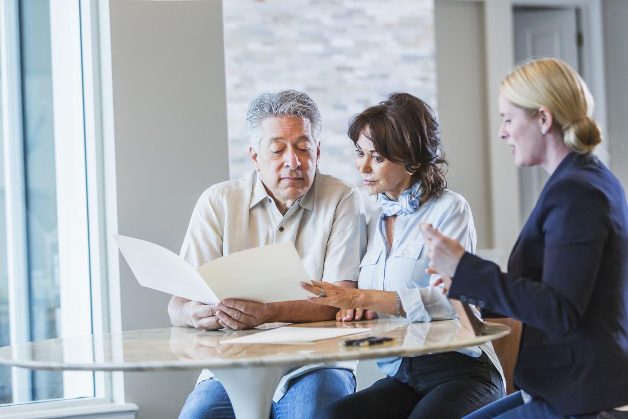 senior couple talking with financial advisor