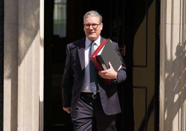 Sir Keir Starmer holding red file