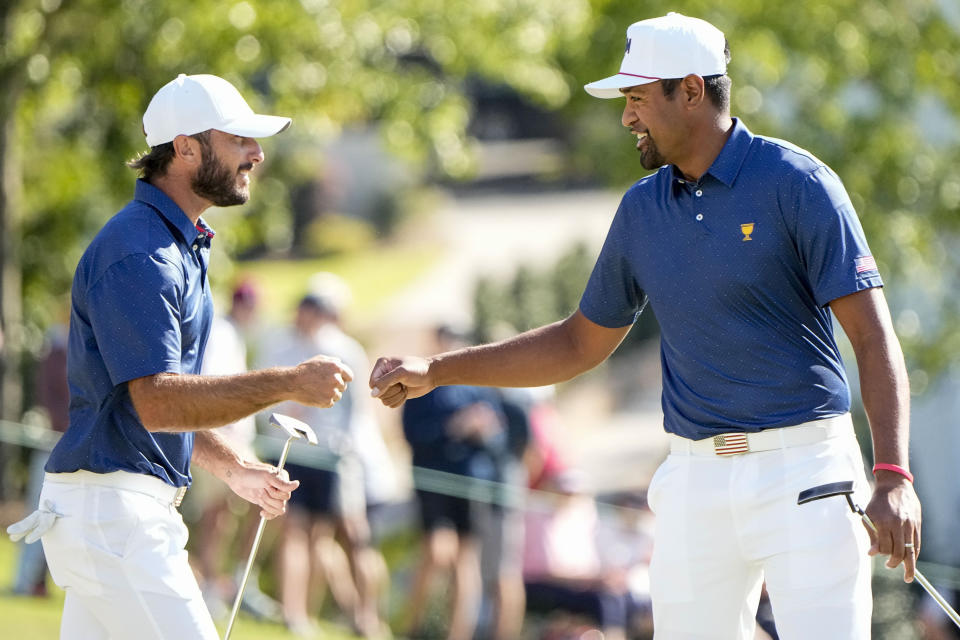 Max Homa and Tony Finau celebrate on the 12th hole during their foursomes match at the Presidents Cup golf tournament at the Quail Hollow Club, Saturday, Sept. 24, 2022, in Charlotte, N.C. (AP Photo/Chris Carlson)