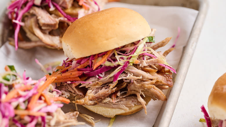 pulled pork sandwiches with coleslaw on tray