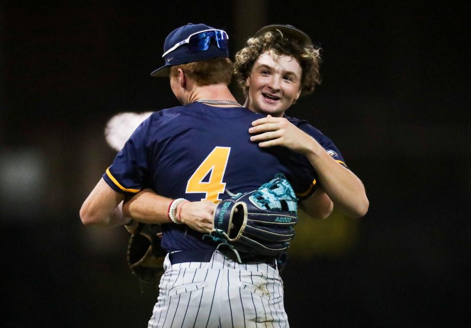 Naples Golden Eagles pitcher Brendan Murphy (2) receives a hug from infielder Johnny King (4) after Murphy gets the final out of the Class 5A Region 3 quarterfinal against the Seminole Warhawks at Naples High School on Tuesday, May 9, 2023.