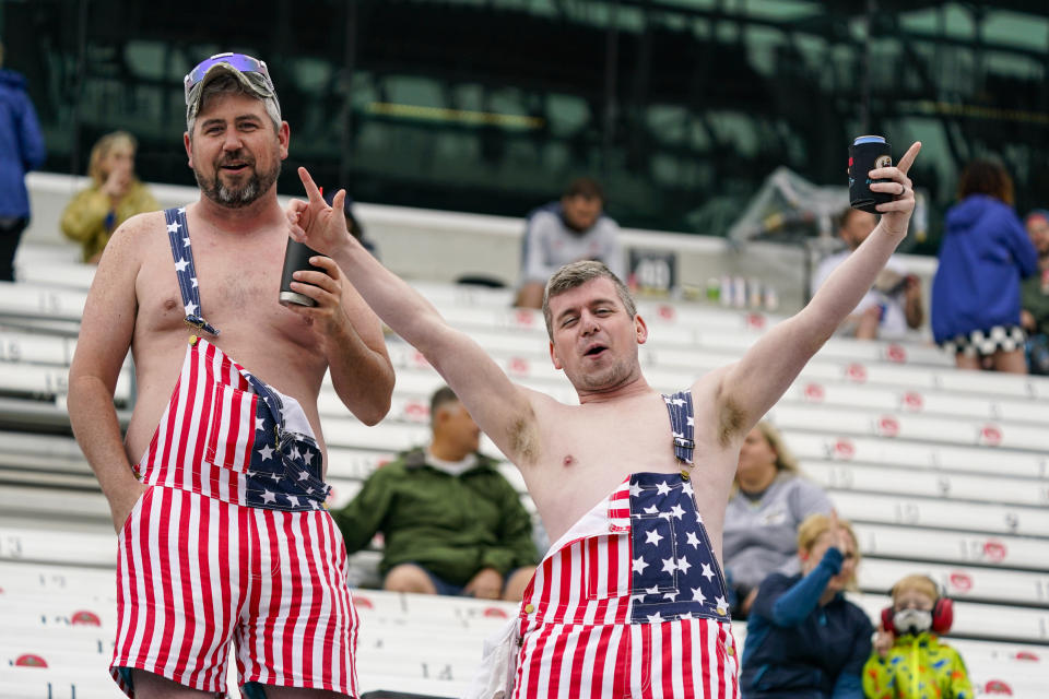 Fans yell from the stands as rain delayed the start of the final practice session for the Indianapolis 500 auto race at Indianapolis Motor Speedway in Indianapolis, Friday, May 28, 2021. (AP Photo/Michael Conroy)