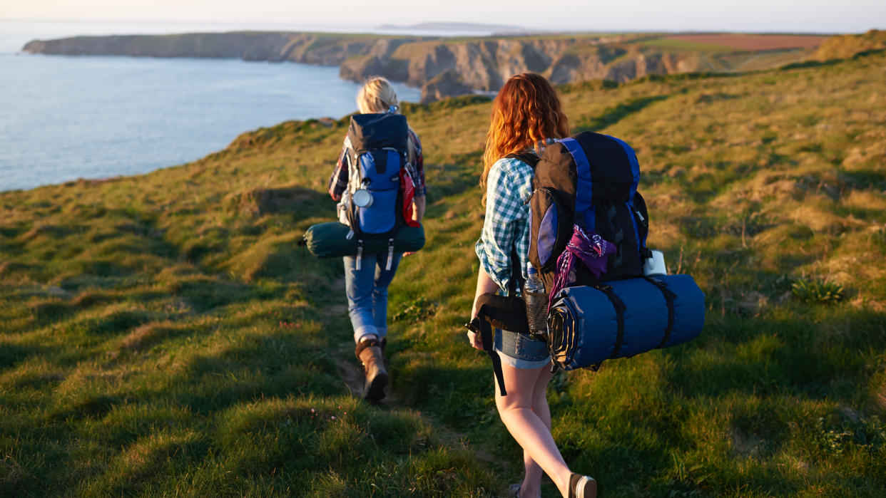  Two female hikers by the coast. 