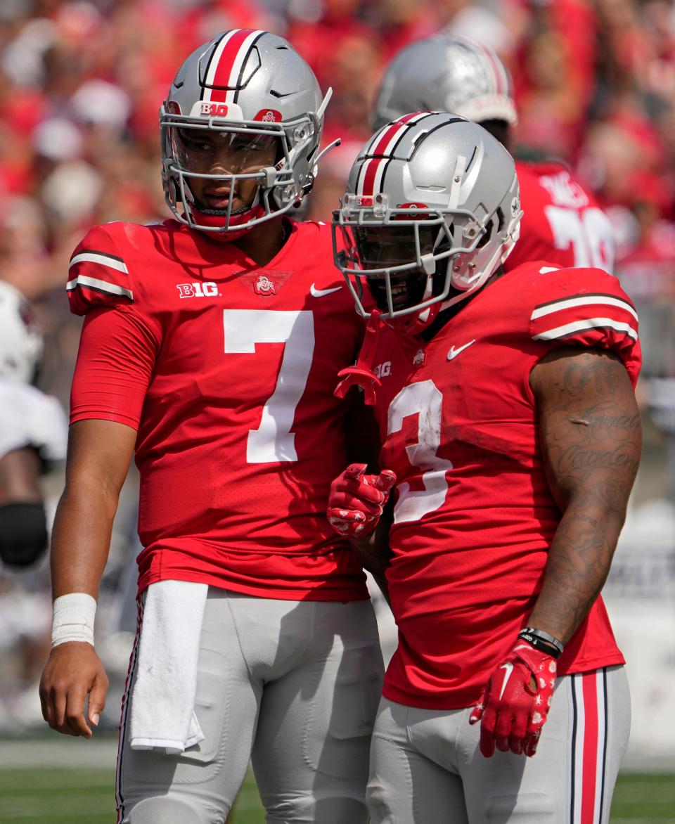 Ohio State quarterback C.J. Stroud (7) talks to running back Miyan Williams during the second half on Saturday.