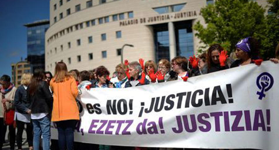 Protesters gather outside the High Court of Navarra behind a banner reading “No is No! Justice!” while awaiting the verdict. Source: Reuters/Vincent West
