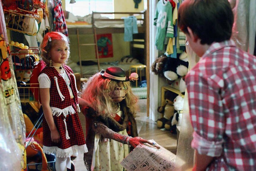 (L-R) Gertie (Drew Barrymore) dresses up  E.T. as Elliott (Henry Thomas) appears in E.T. (1982)