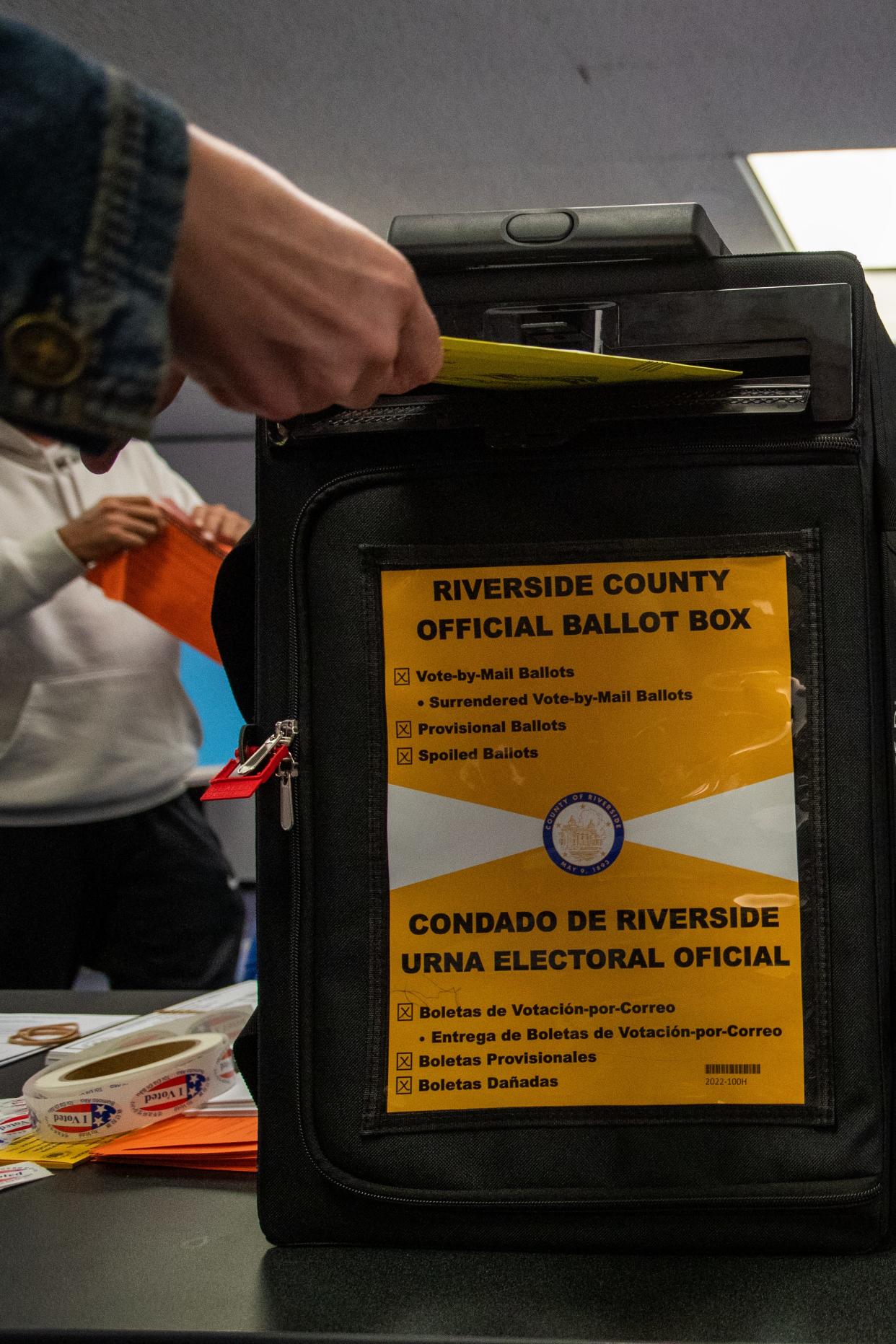 A voter drops off their ballot at the Palm Springs Public Library on Nov. 8.