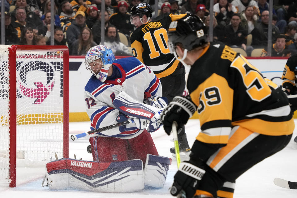 A shot by Pittsburgh Penguins' Drew O'Connor (10) gets behind New York Rangers goaltender Jonathan Quick (32) but stays out of the net during the second period of an NHL hockey game in Pittsburgh, Wednesday, Nov. 22, 2023. (AP Photo/Gene J. Puskar)