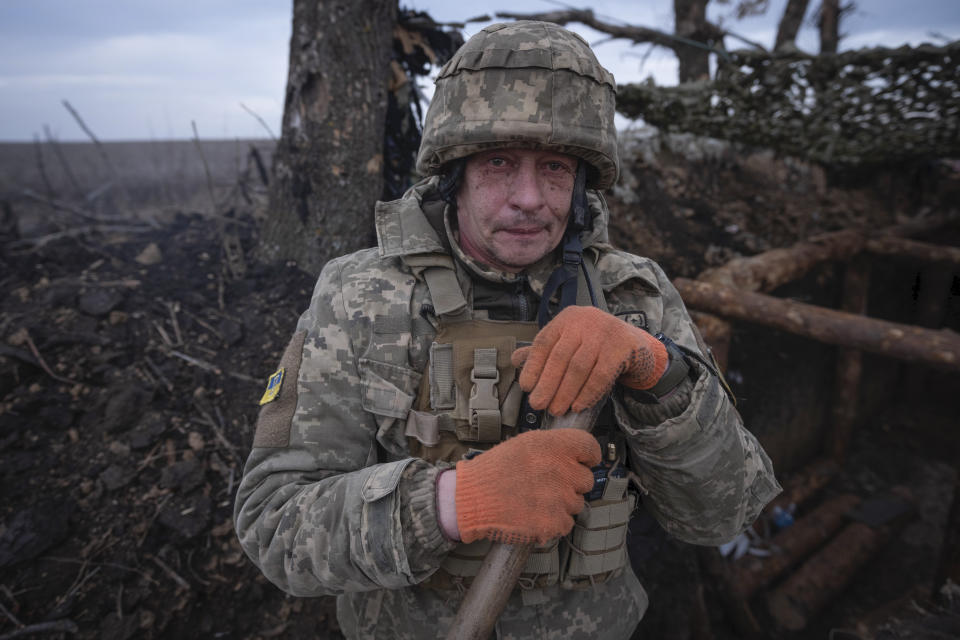 A Ukrainian soldier looks at the camera as he digs a trench on the front-line near Klishchiivka, Donetsk region, Ukraine, Monday, March 18, 2024. (Iryna Rybakova via AP)
