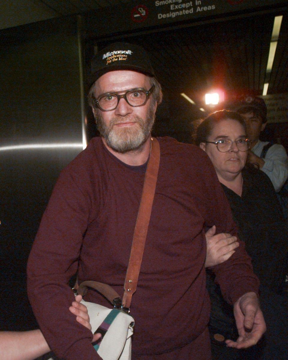 Lewis is escorted through Boston’s Logan Airport, Friday Oct. 13, 1995, after being released from jail (Copyright 1995 The Associated Press. All rights reserved)