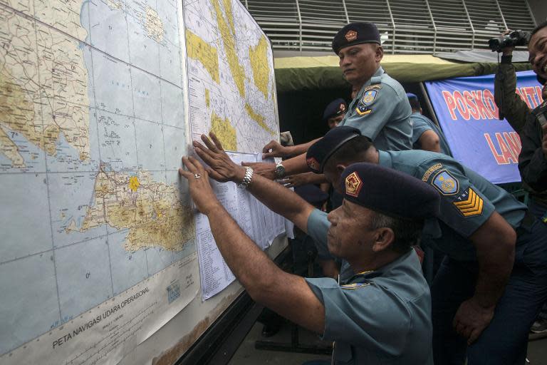 Indonesian Air Force officials show the search area for missing AirAsia flight QZ8501 at a press conference at the airport in Surabaya on December 29, 2014