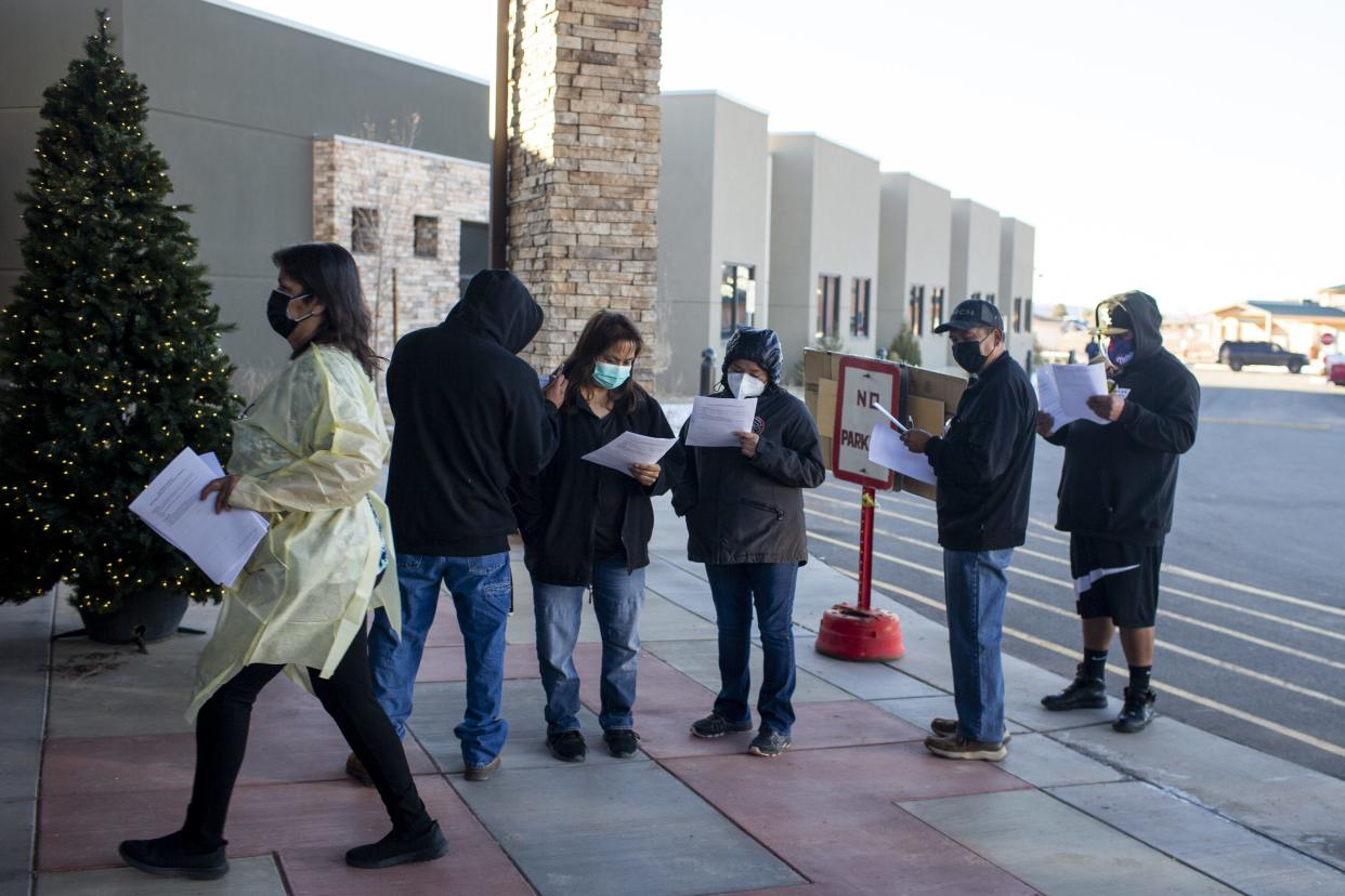 People wait in line at the Dr. Guy Gorman Senior Care Home to receive the Pfizer COVID-19 vaccine on the Navajo Nation in Chinle on Dec. 18, 2020.