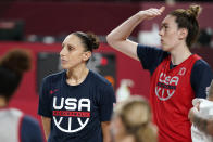 United States' Diana Taurasi and Breanna Stewart, right, huddle with teamamtes during a women's basketball practice at the 2020 Summer Olympics, Saturday, July 24, 2021, in Saitama, Japan. (AP Photo/Charlie Neibergall)