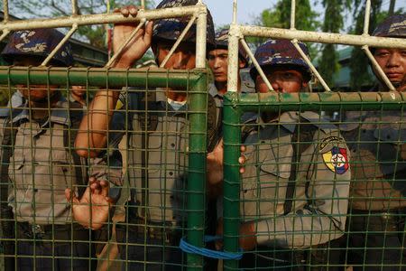 Police stand guard in front of a court, after the arrival of student protesters, in Letpadan March 11, 2015. REUTERS/Soe Zeya Tun