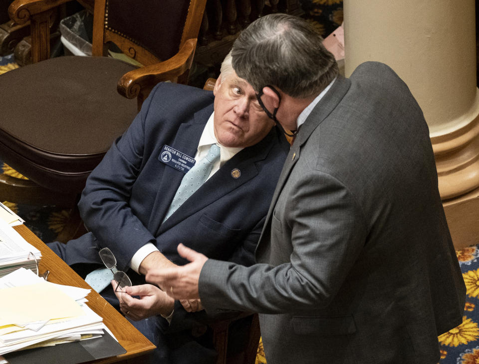 Sen. Bill Cowsert (R-Athens) speaks with Sen. Larry Walker, III, (R-Perry) during debate on a bill to reform the citizens arrest law Monday, March 29, 2021. Georgia state senators voted 34-18 for a bill that loosens the state's gun laws less than two weeks after police say a man bought a gun and killed eight people at three different massage businesses. (Ben Gray/Atlanta Journal-Constitution via AP)