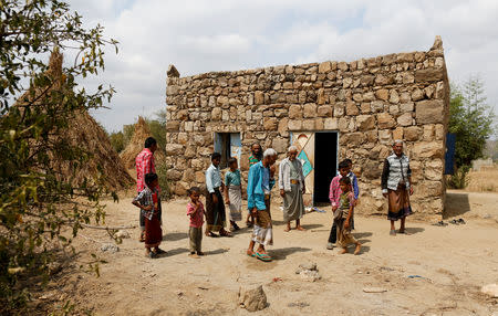 People stand outside a mosque in the village of al-Jaraib, in the northwestern province of Hajjah, Yemen, February 19, 2019. REUTERS/Khaled Abdullah