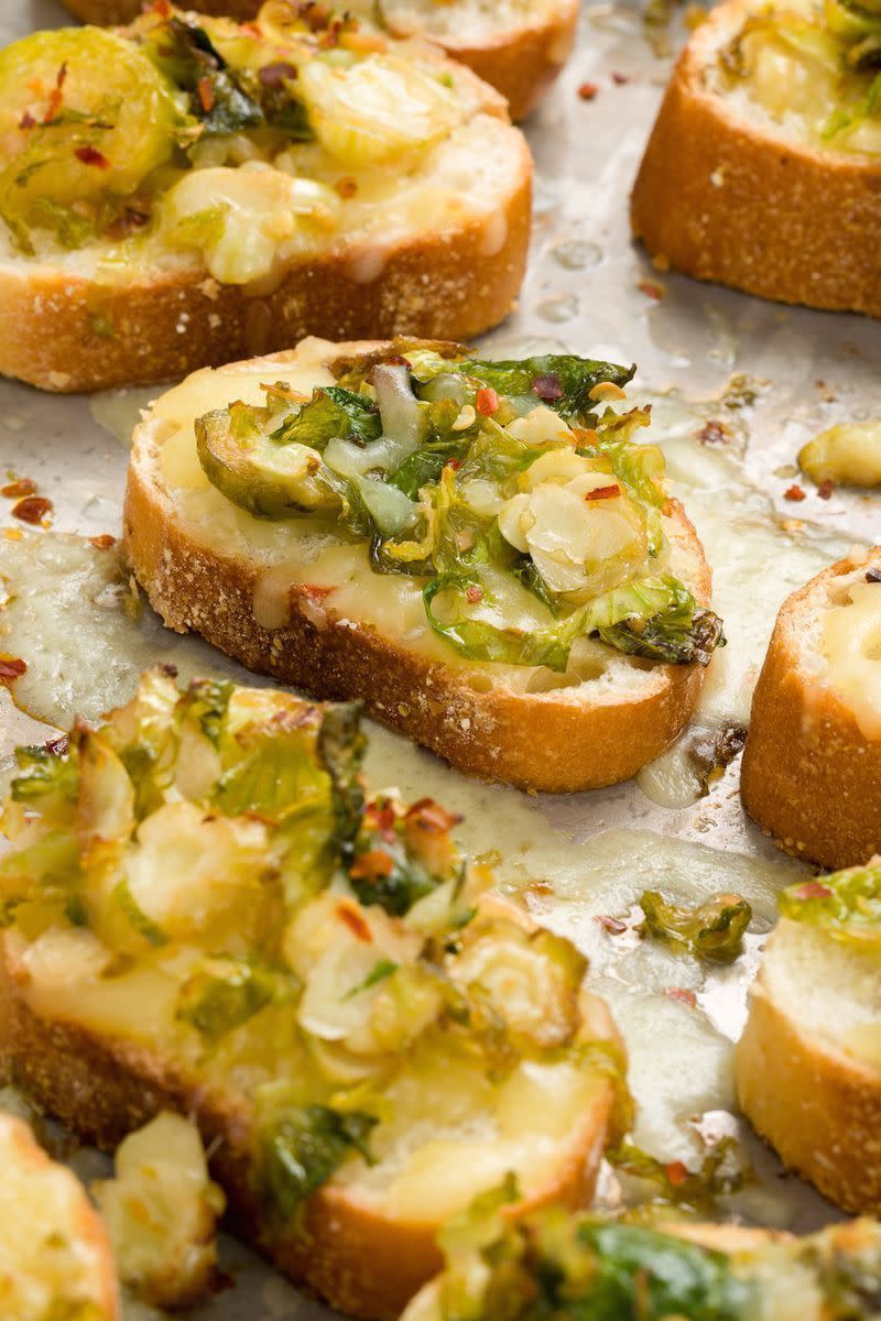 <p>Shredded Brussels sprouts sautéed in a mixture of garlic and chilli flakes, then topped on toasts with white cheddar will leave you saying "Insane!" in the best way.</p><p>Get the <a href="https://www.delish.com/uk/cooking/recipes/a33664233/cheesy-brussels-sprouts-mini-toasts-recipe/" rel="nofollow noopener" target="_blank" data-ylk="slk:Cheesy Brussels Sprouts Mini Toasts;elm:context_link;itc:0;sec:content-canvas" class="link ">Cheesy Brussels Sprouts Mini Toasts</a> recipe.</p>