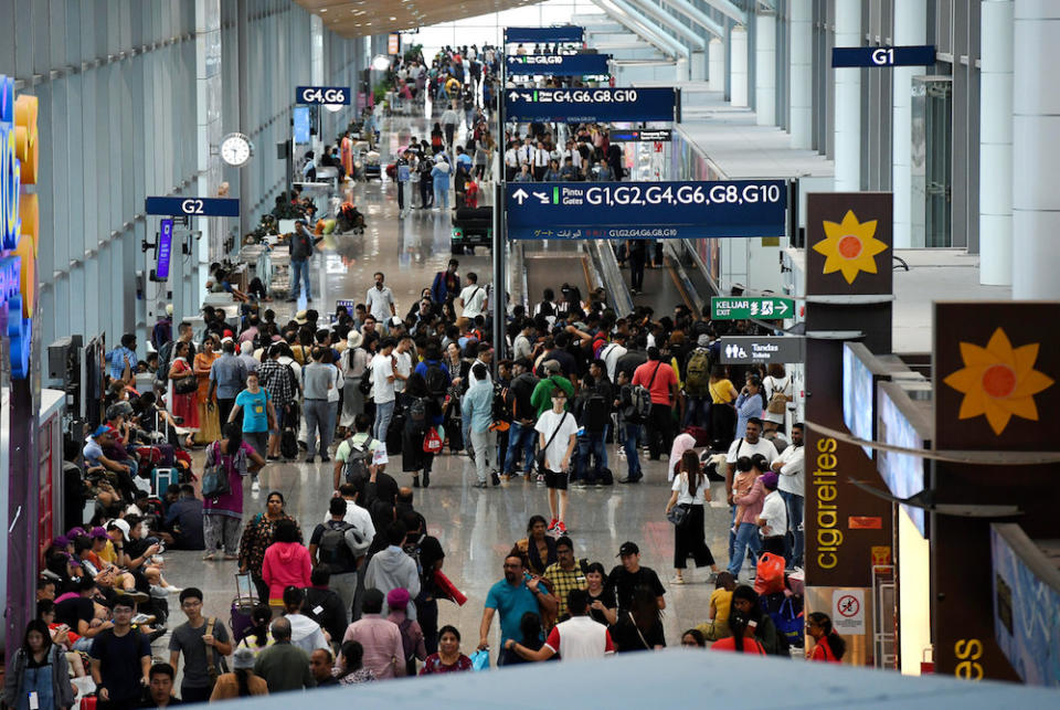 Passengers queue at their respective boading gates at KLIA in Sepang August 23, 2019. — Bernama pic