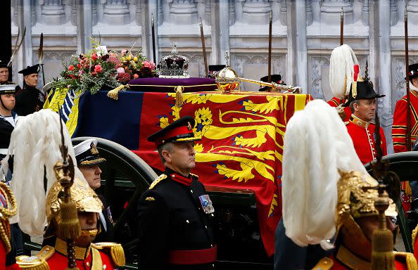 LONDON, ENGLAND - SEPTEMBER 19: The coffin of Queen Elizabeth II with the Imperial State Crown resting on top is carried into Westminster Abbey on September 19, 2022 in London, England. Elizabeth Alexandra Mary Windsor was born in Bruton Street, Mayfair, London on 21 April 1926. She married Prince Philip in 1947 and ascended the throne of the United Kingdom and Commonwealth on 6 February 1952 after the death of her Father, King George VI. Queen Elizabeth II died at Balmoral Castle in Scotland on September 8, 2022, and is succeeded by her eldest son, King Charles III.  (Photo by Tristan Fewings/Getty Images)