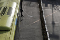 A man boards a bus in Quezon city, Philippines, Saturday, Sept. 26, 2020. Public transportation remains limited and the government orders commuters to wear face shields and face masks to help curb the spread of the coronavirus. (AP Photo/Aaron Favila)