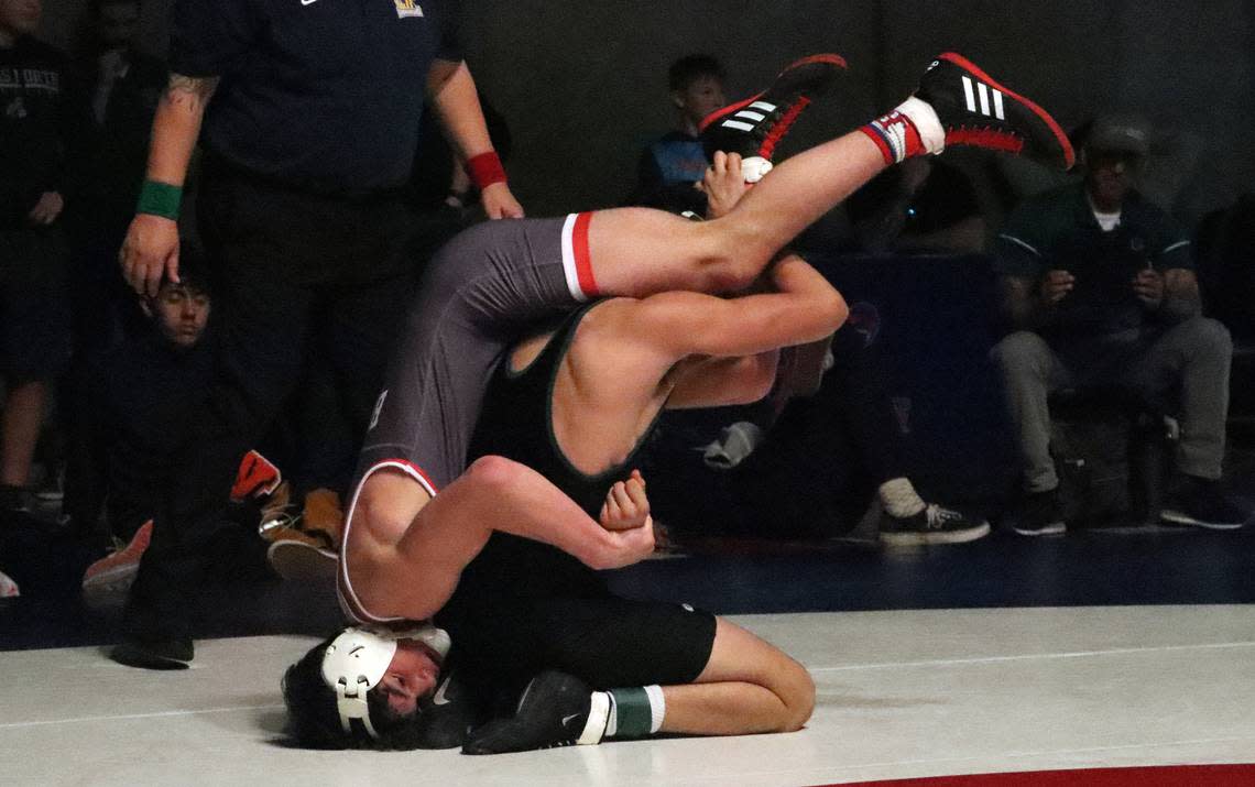 Buchanan High 154-pound wrestler Leo Contino finds himself upside down during a 5-0 win over Dinuba High’s Coen Quintana in the CIF Central Section wrestling championships at Buchanan High on Feb. 18, 2023.