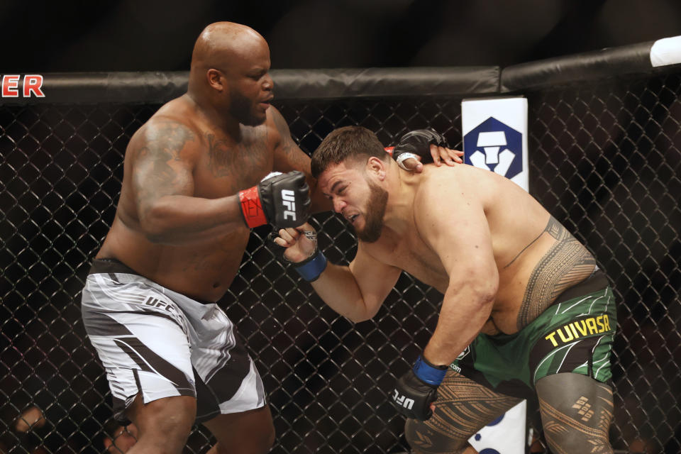 Feb 12, 2022; Houston, Texas, UNITED STATES; Derrick Lewis (red gloves) fights Tai Tuivasa (blue gloves) during UFC 271 at Toyota Center. Mandatory Credit: Troy Taormina-USA TODAY Sports