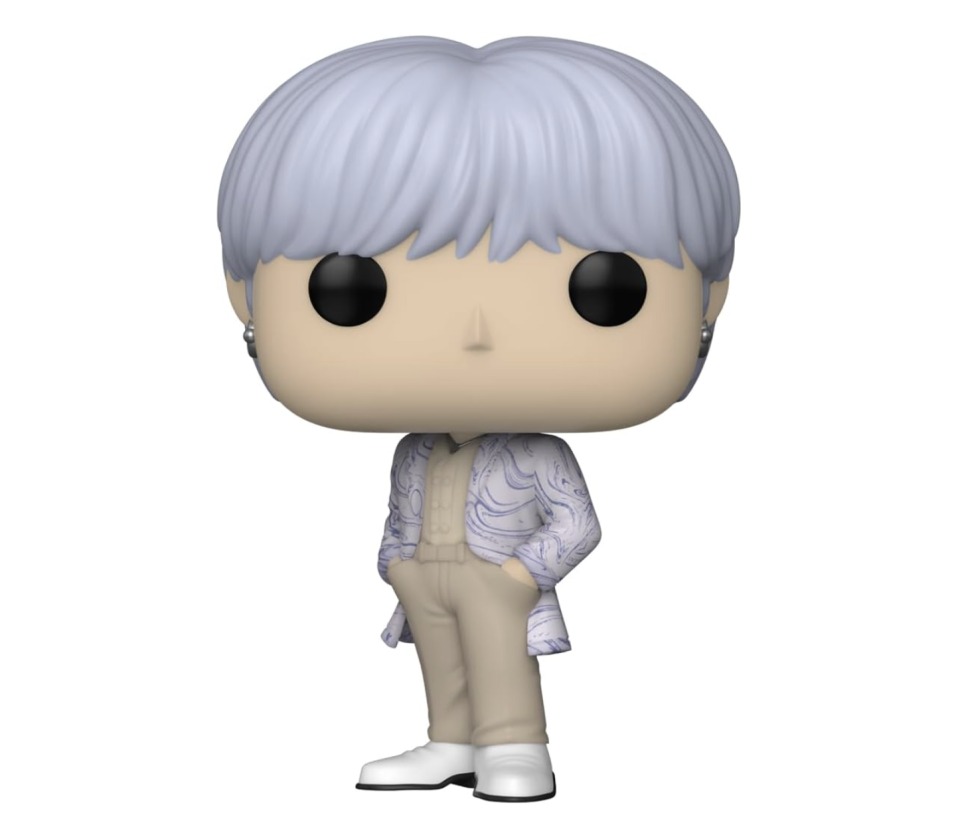 figurine with white hair, matching blazer and beige top and bottoms