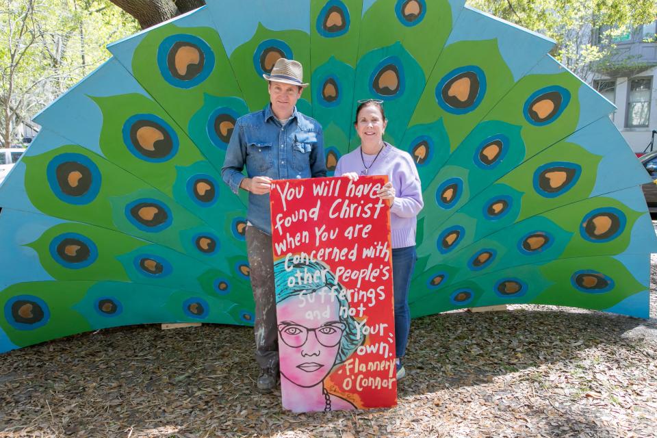 Panhandle Slim (L) hosted a pop-up art show during the Flannery O'Connor birthday celebration, and one of his pieces was purchased by Kitty Sutton, an English teacher from Columbia, SC.