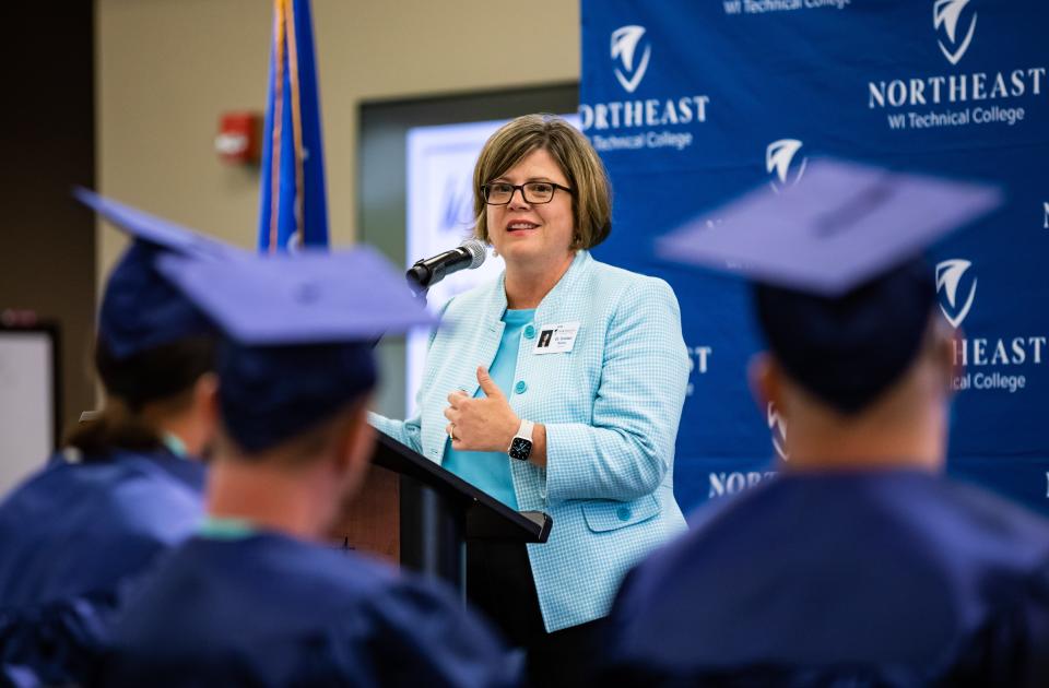 Northeastern Wisconsin Technical College President Kristen Rainey speaks to 11 students from the Sanger B. Powers Correctional Center at their graduation ceremony, where they earned certificates in Industrial Maintenance on Thursday in Green Bay.