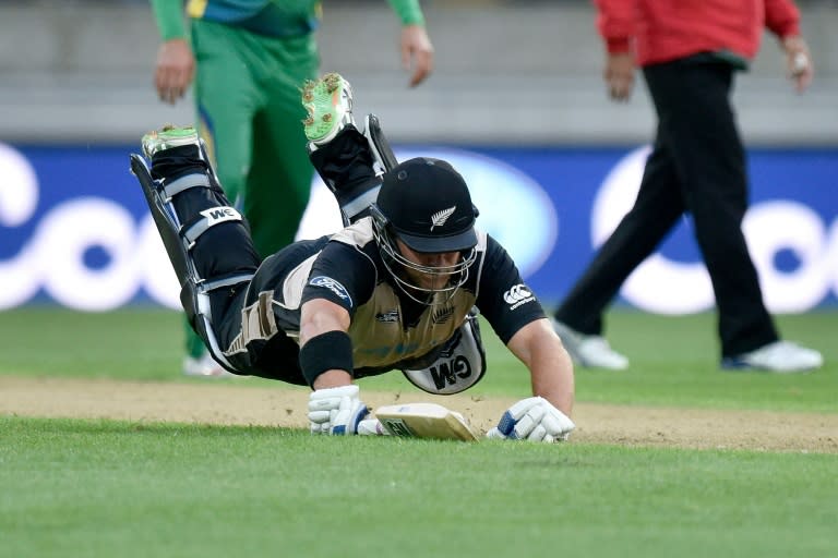 Corey Anderson of New Zealand dives to safety during the third T20 cricket match between New Zealand and Pakistan at Westpac Stadium in Wellington on January 22, 2016