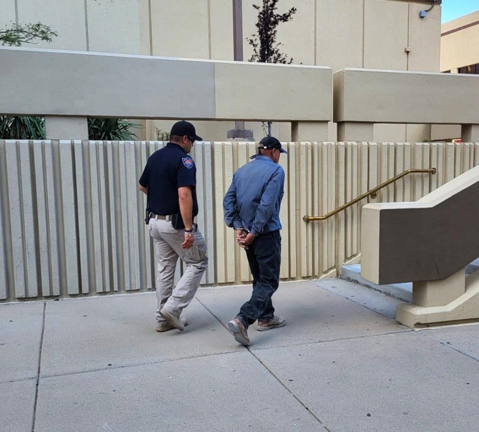 A Horizon City police officer escorts Benito Lincona Cabrera into the El Paso County Jail in Downtown El Paso on Friday. Cabrera is one of two drivers suspected in the hit-and-run death of a bicyclist on Sept. 25 on Horizon Boulevard.