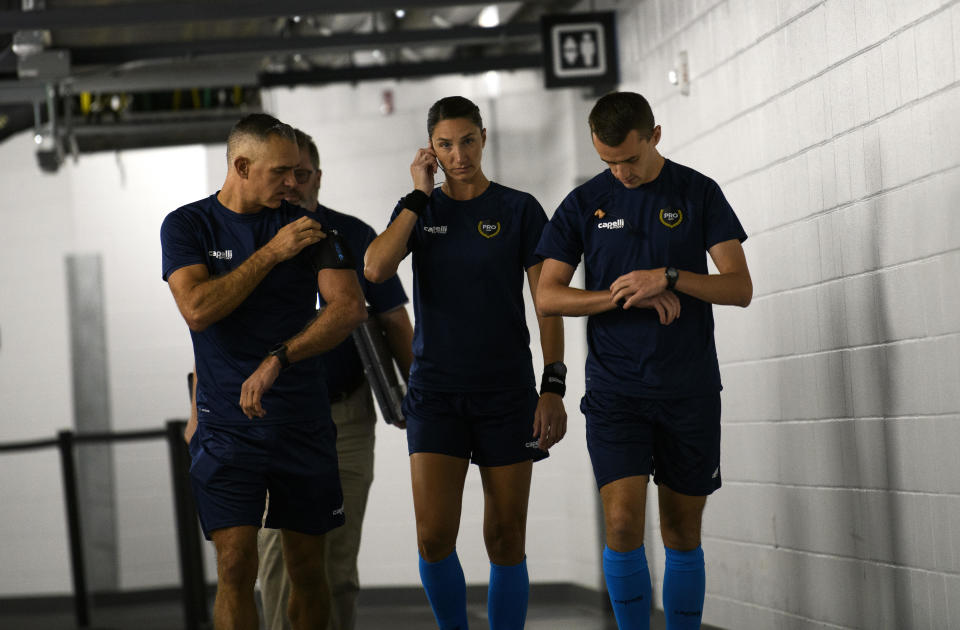 Katy Nesbitt (C) walks out to the pitch for warmups with her fellow referees Timothy Ford (L) and Kevin Lock (R) before the game between Minnesota United FC and LAFC at Allianz Field in St. Paul, Minnesota on September 13, 2022.  / Credit: Getty Images 