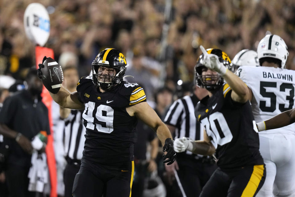 Iowa defensive lineman Ethan Hurkett (49) celebrates after recovering a fumble during the second half of an NCAA college football game against Michigan State, Saturday, Sept. 30, 2023, in Iowa City, Iowa. Iowa won 26-16. (AP Photo/Charlie Neibergall)