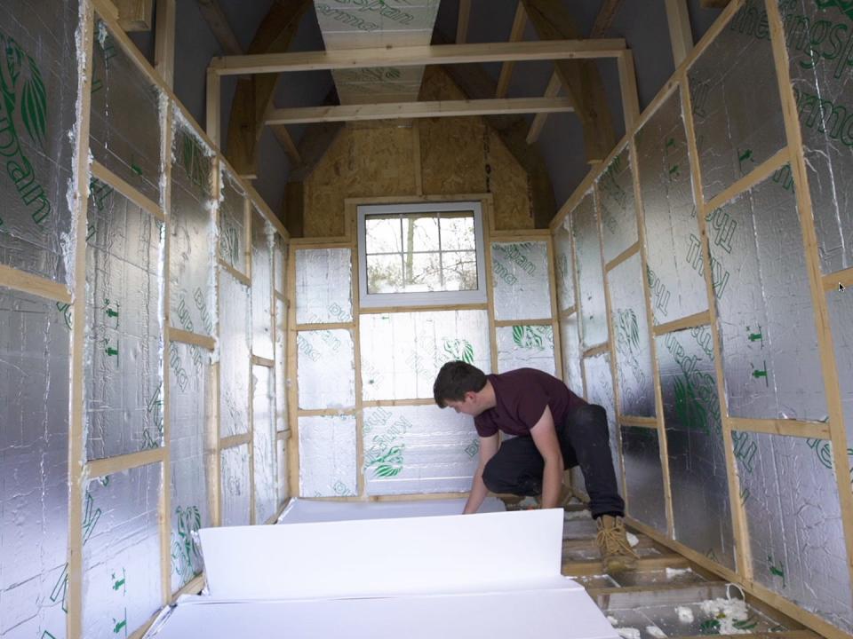 Photo of Jacob Harrell building the tiny home.