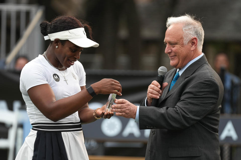 Austin mayor Kirk Watson presents Sloane Stephens with the 2023 Catalyst award Thursday night along with a $250,000 check to her foundation that works to introduce tennis to young players.