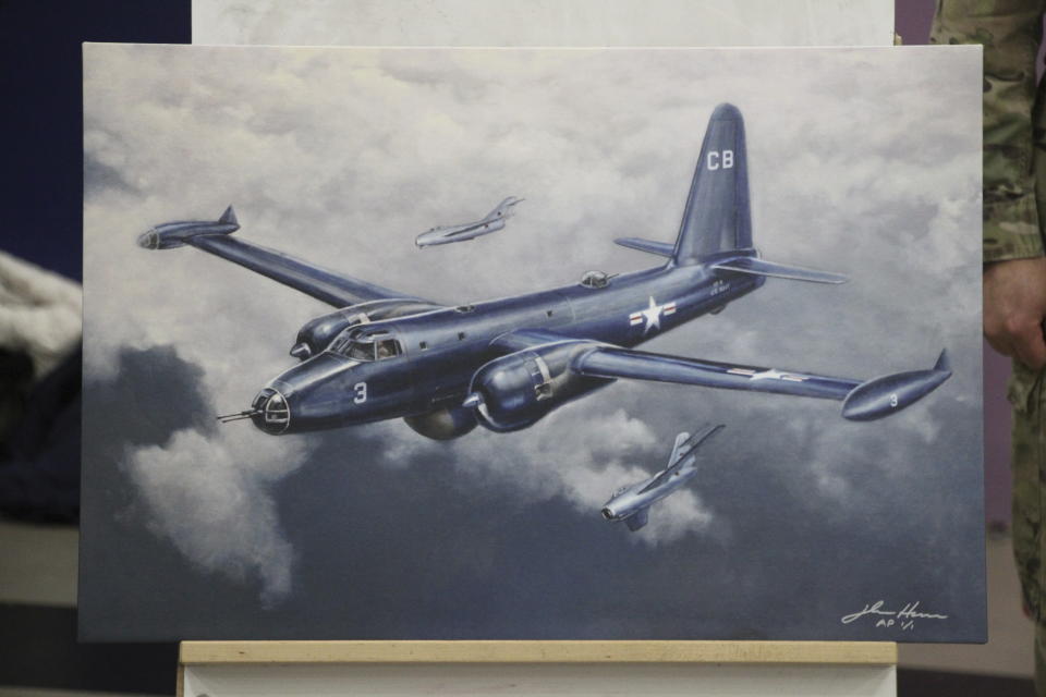 This March 28, 2023, photo shows a depiction by artist John Hume of the Navy Neptune that was shot down by Soviet MiG-15s on June 22, 1955, as displayed in Gambell, Alaska. Sixteen Alaska National Guard members were honored with Alaska Heroism Medals for helping rescue the crew after the plane crash-landed on St. Lawrence Island. Hume donated the print to the Village of Gambell. (AP Photo/Mark Thiessen)